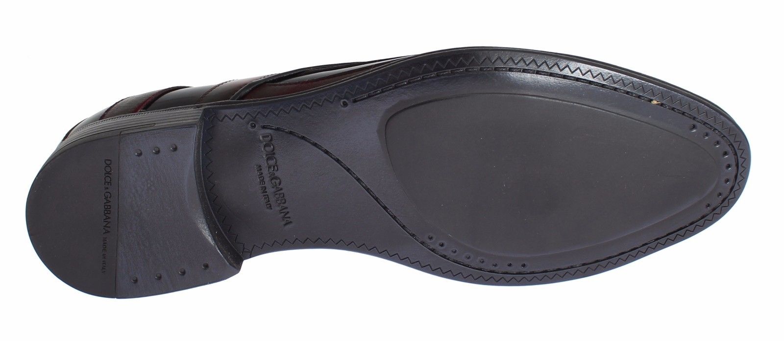 A single black dress shoe with a strap across the top and a small heel