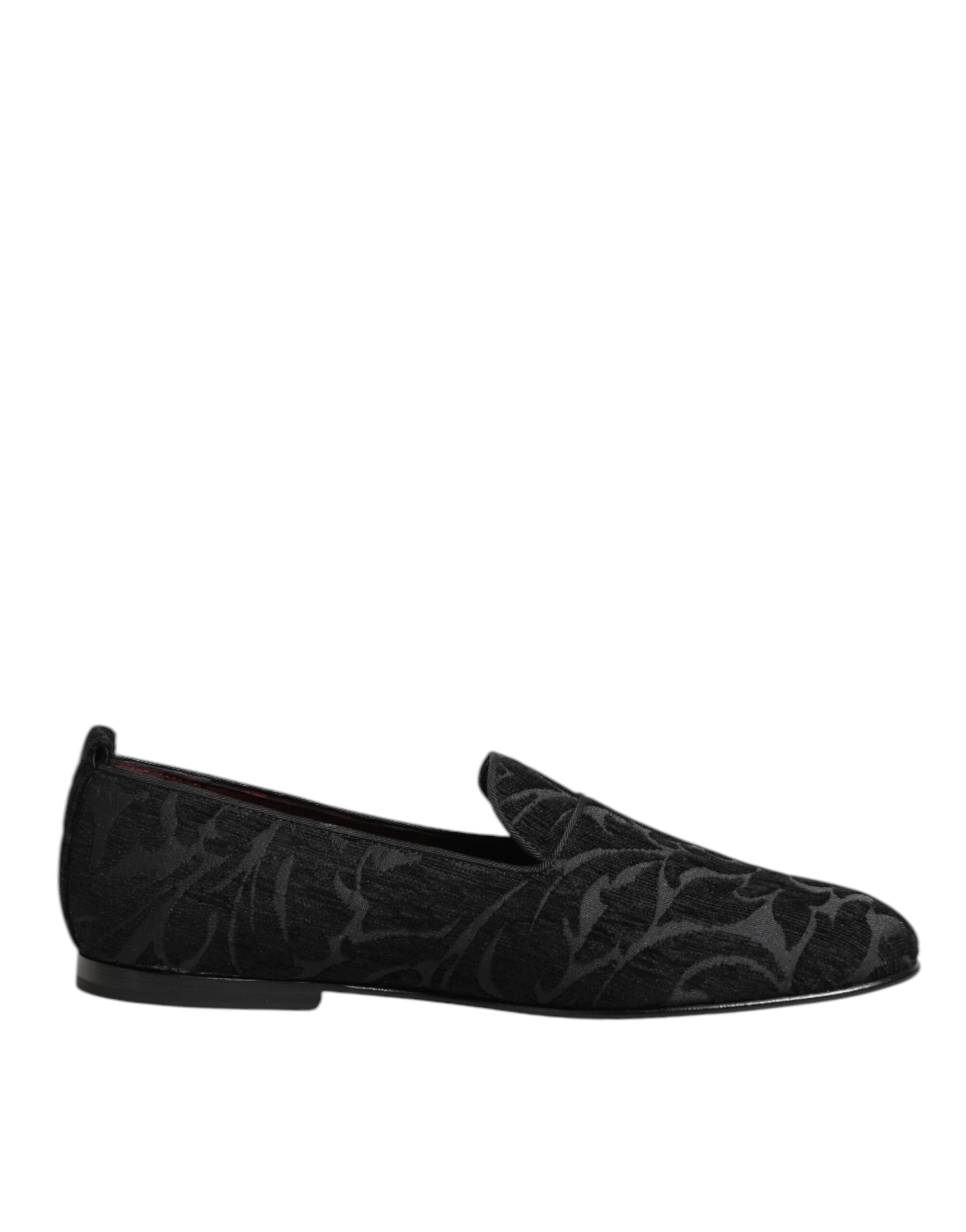 A pair of black brocade loafers with a slip-on design, featuring a patterned texture