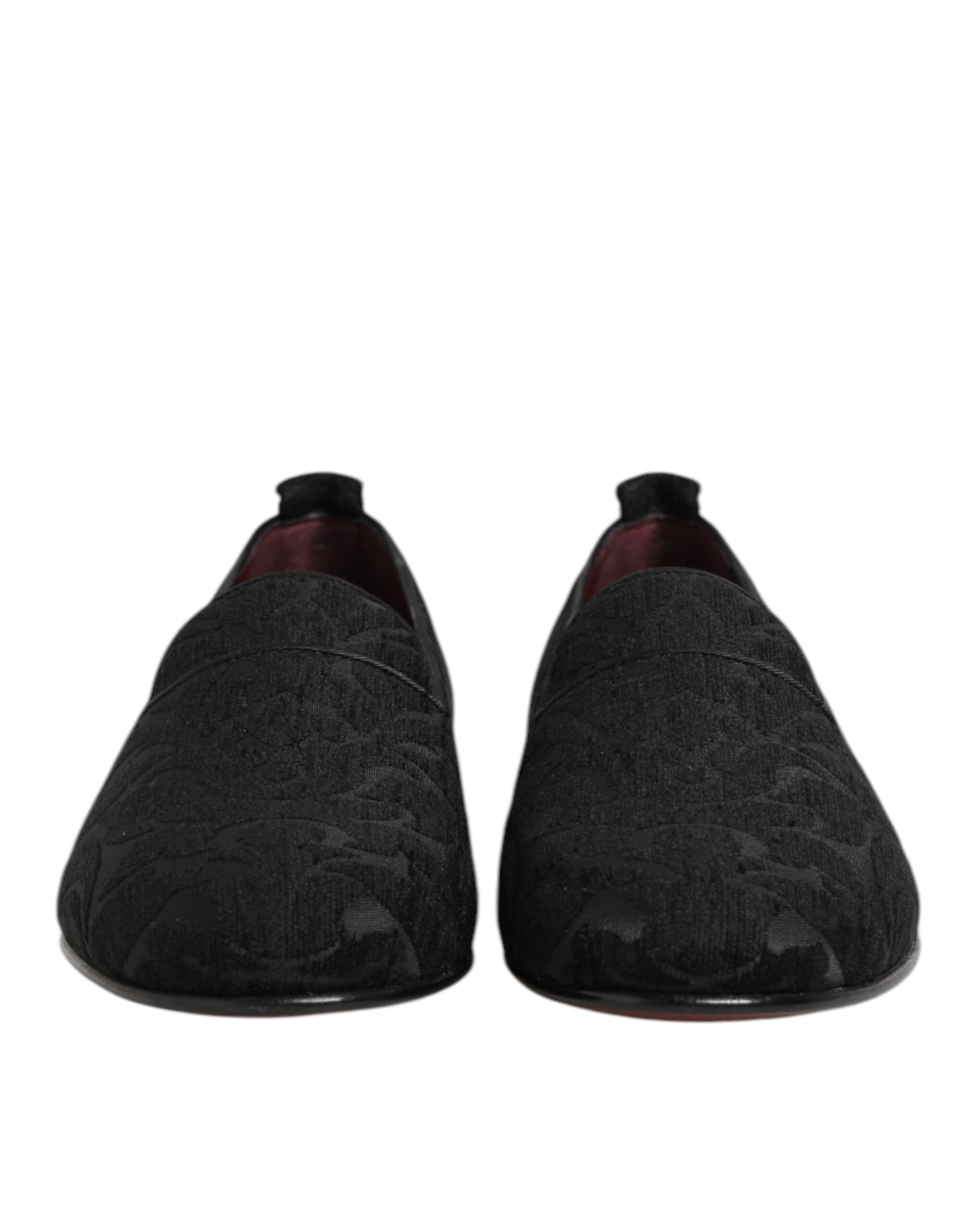 Pair of black brocade loafers with red soles, slip-on style