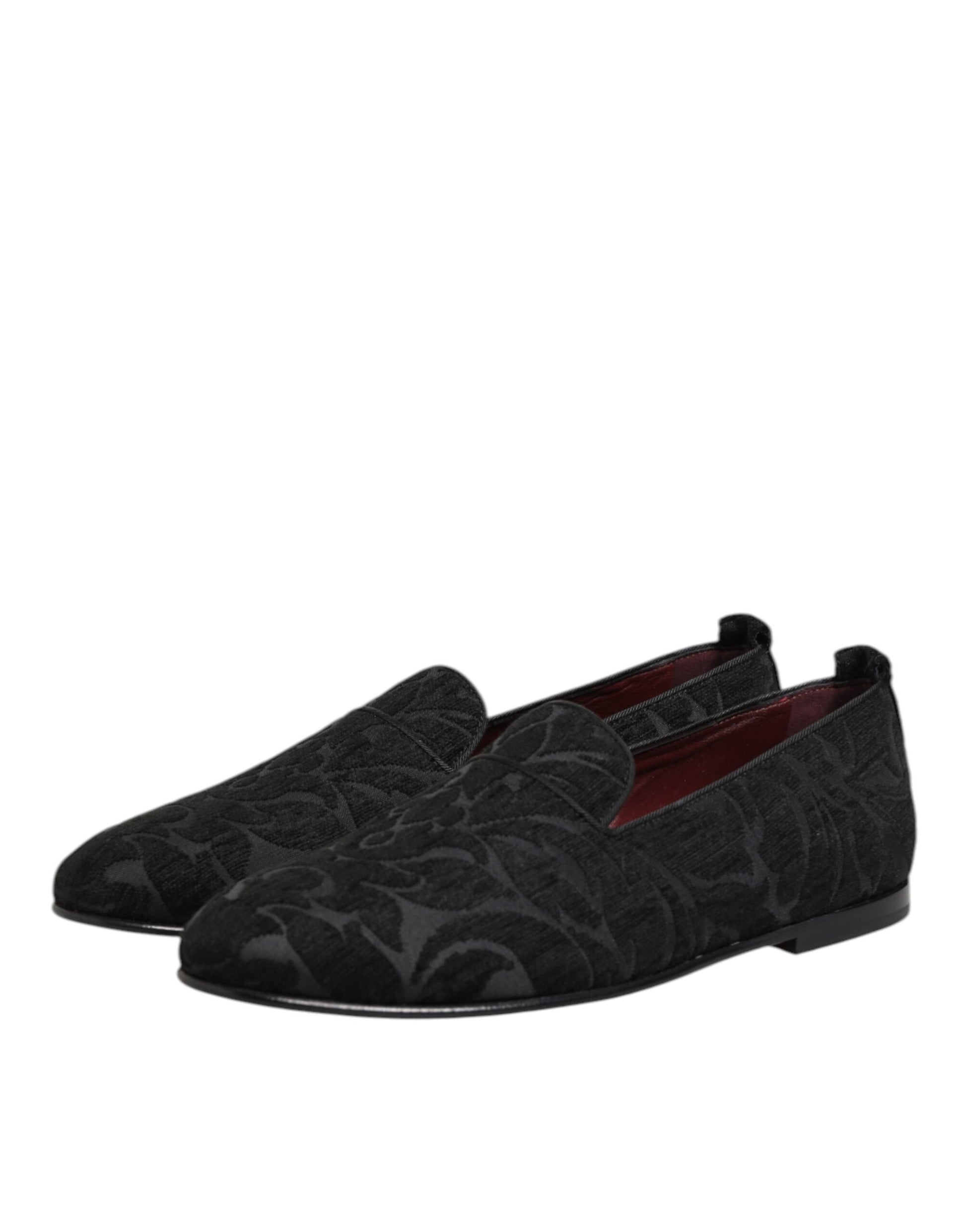 A pair of black brocade loafers with red accents, featuring a slip-on design