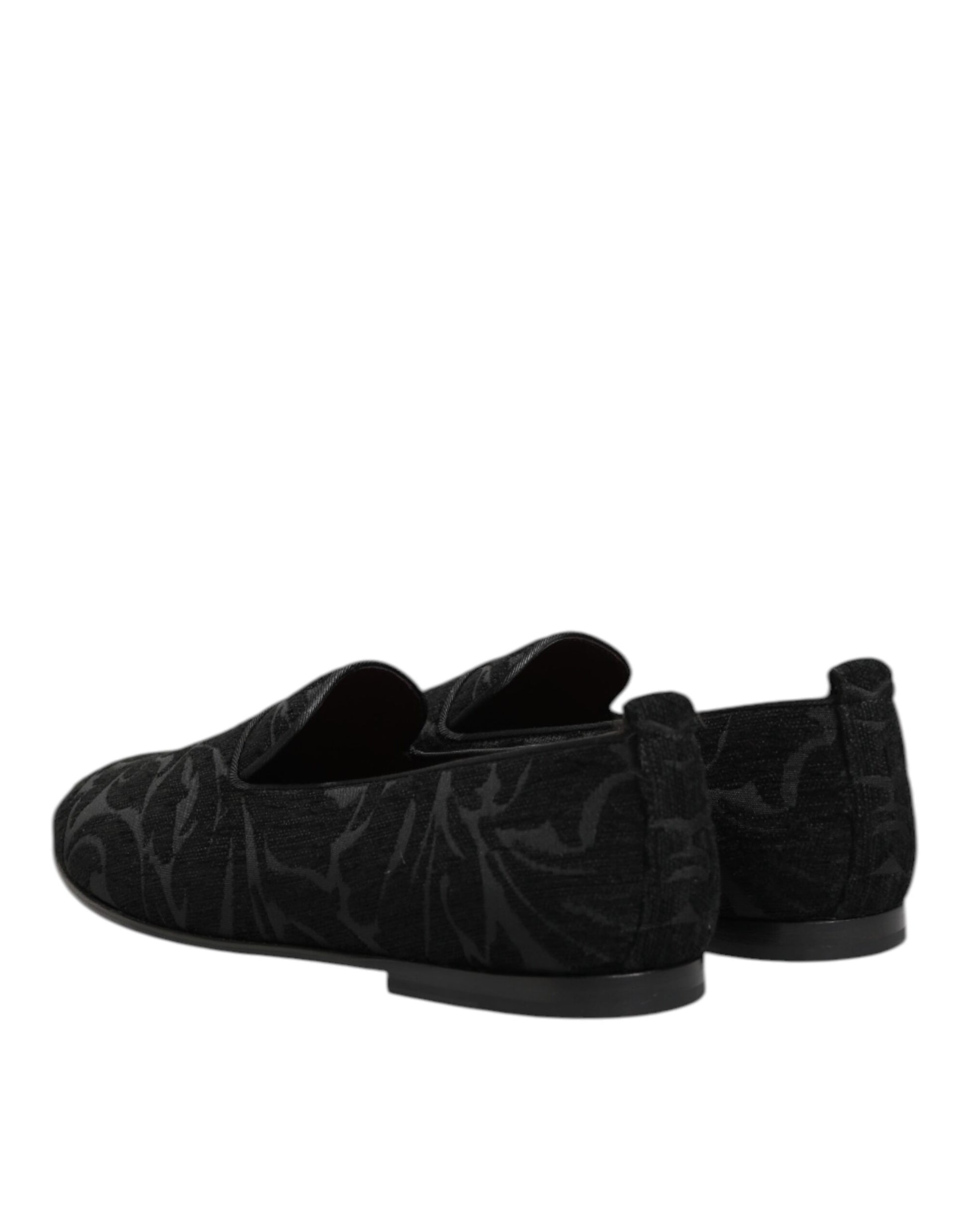 A pair of black brocade loafers with a slip-on design, featuring intricate patterns and embellishments