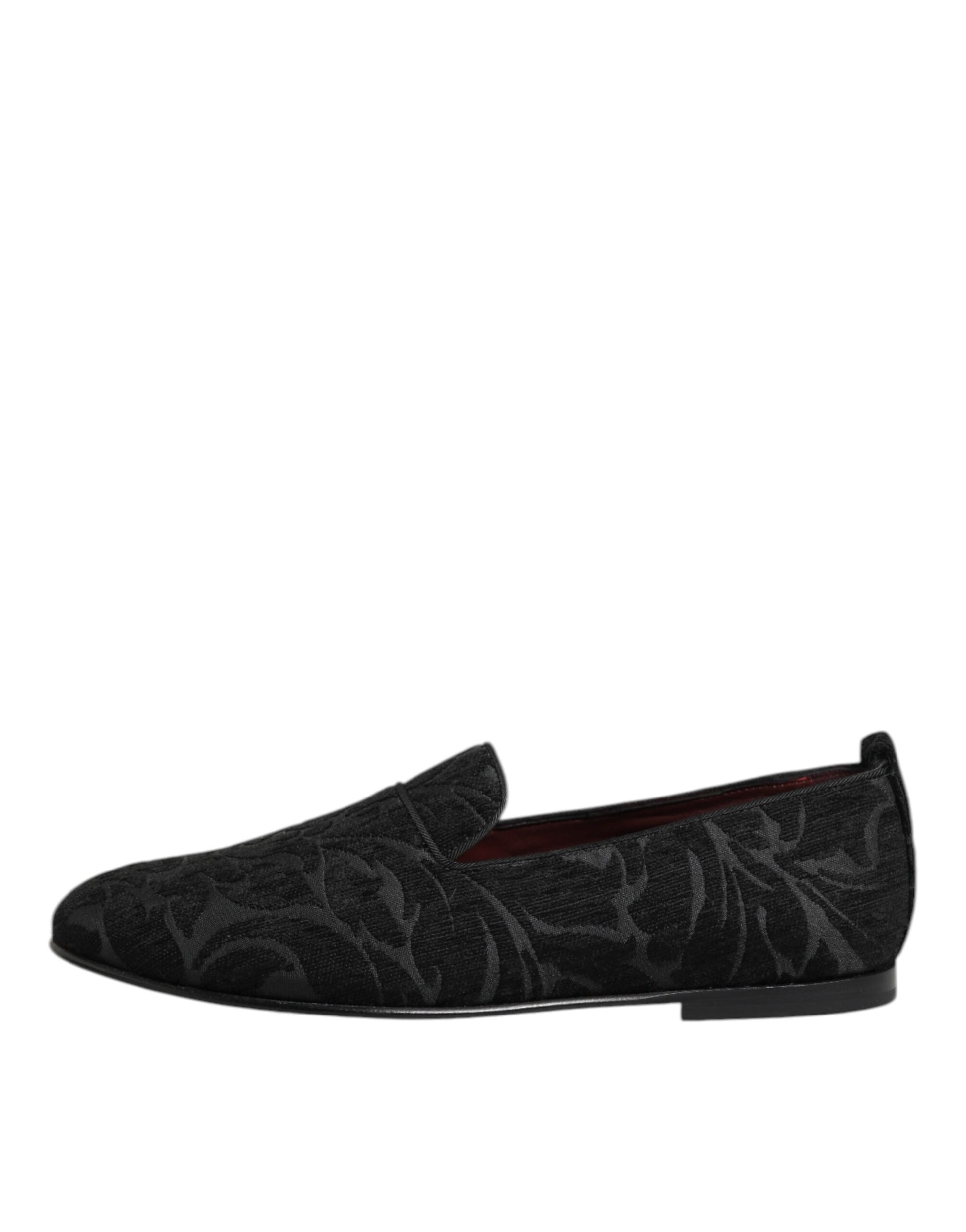 A pair of black brocade loafers with red accents, featuring a slip-on design