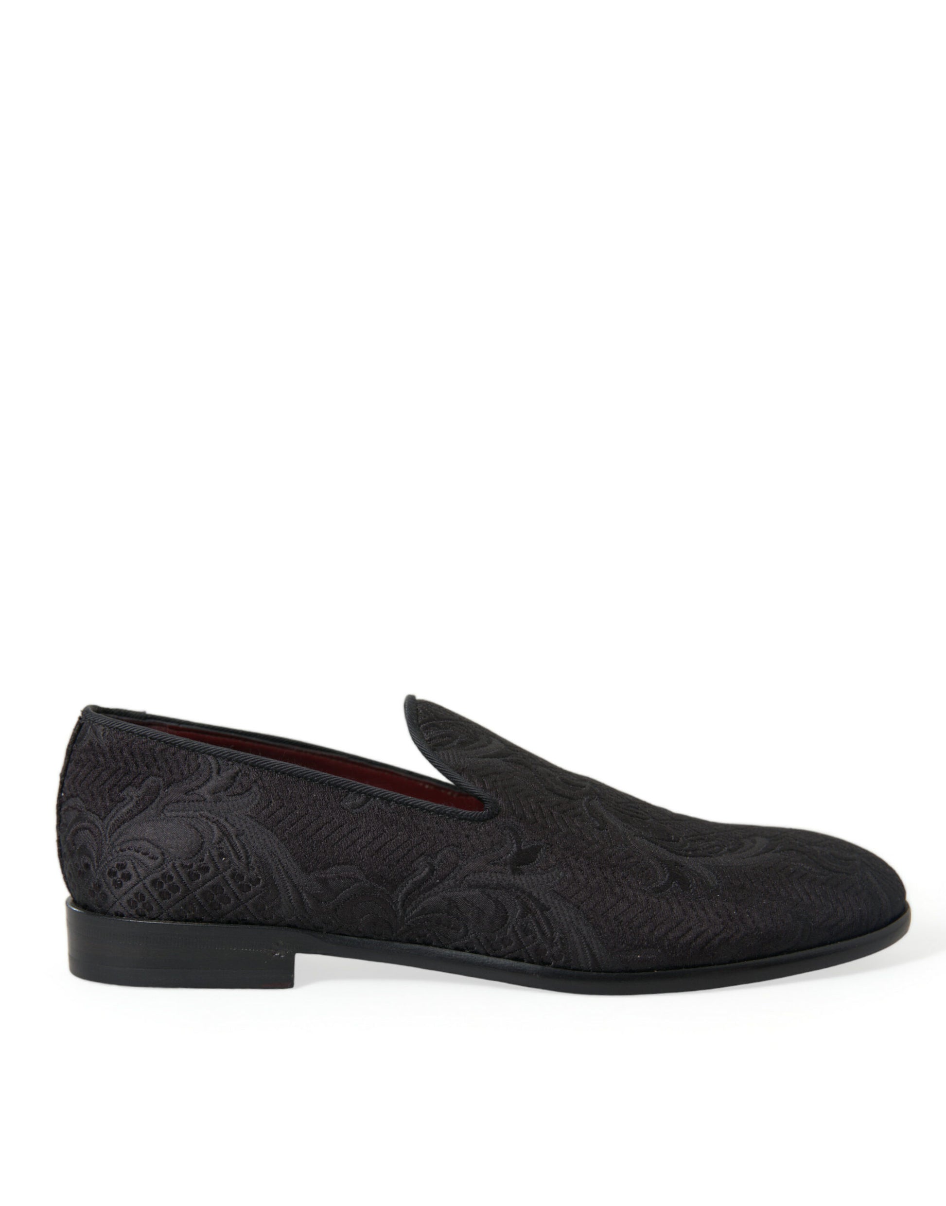 Pair of black loafers with red accents and patterned design on soles