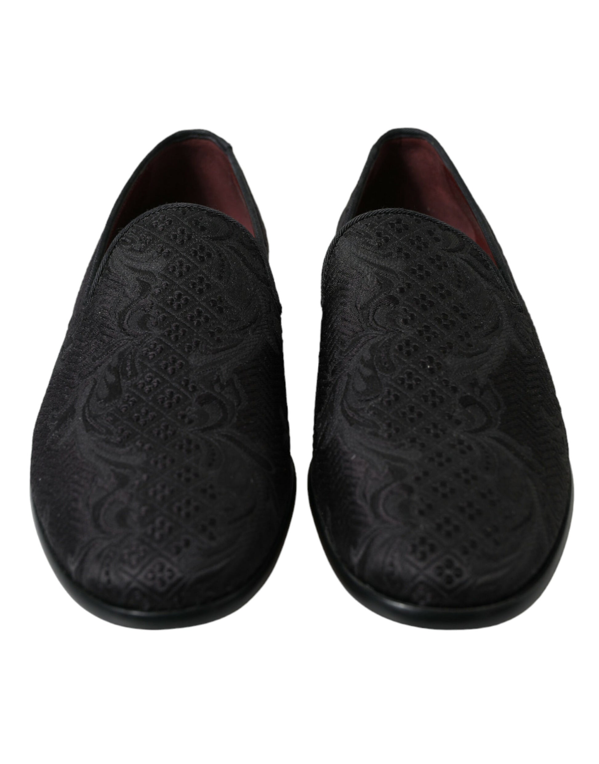 Pair of black slippers with embroidered design on soles