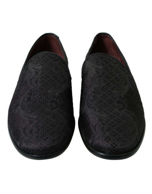 Pair of black slippers with embroidered design on soles