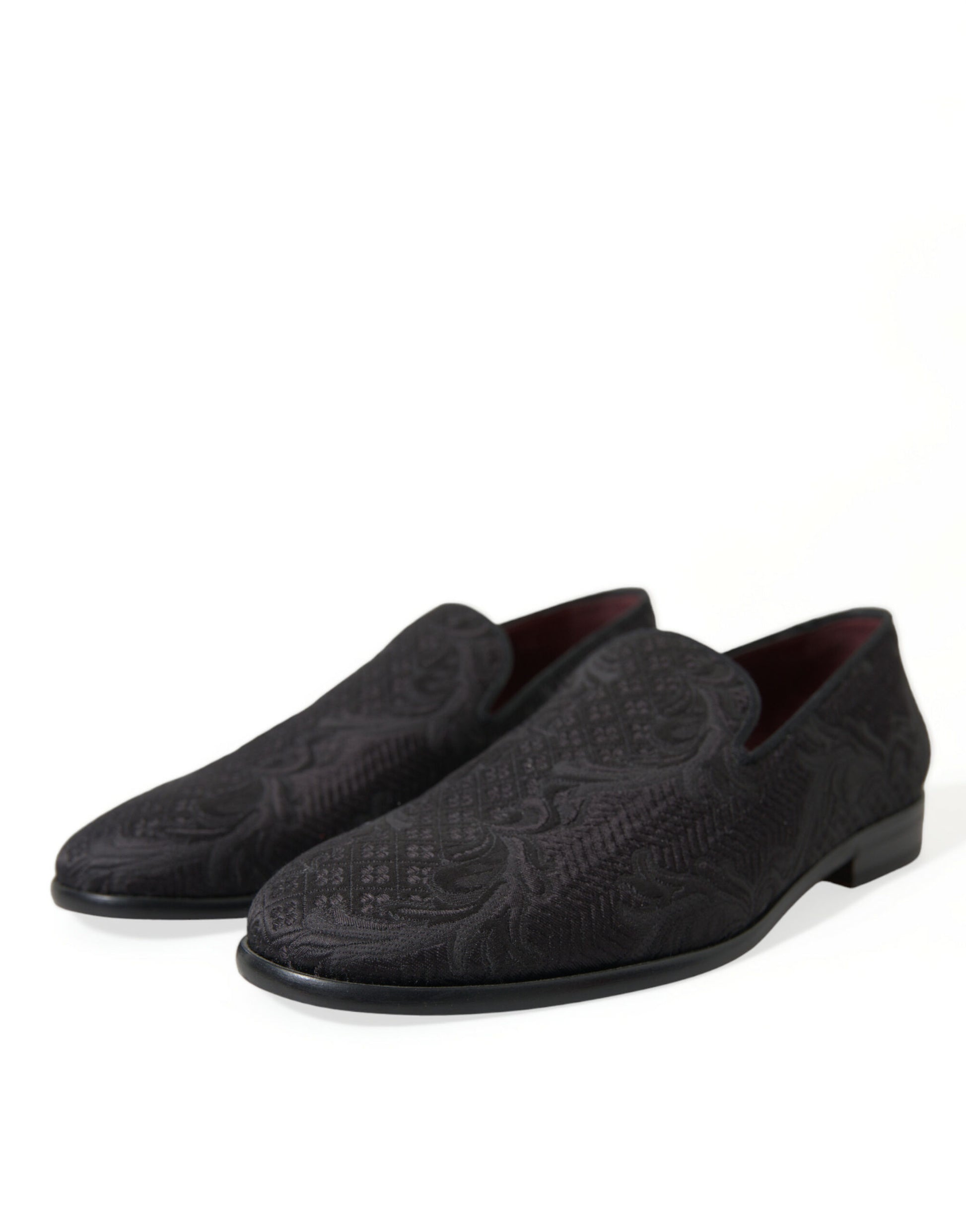 Pair of black loafers with embossed design on soles
