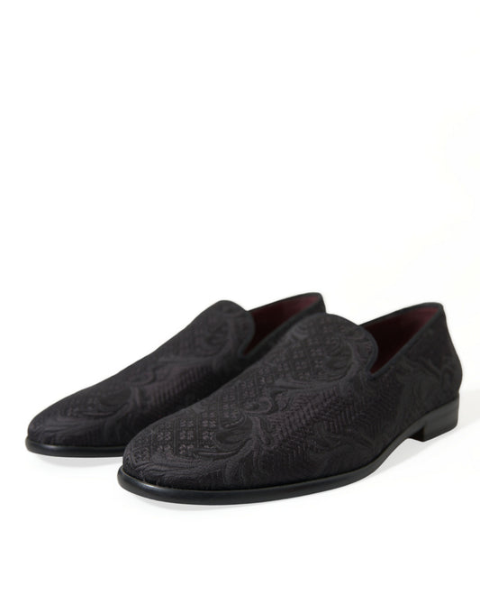Pair of black loafers with embossed design on soles