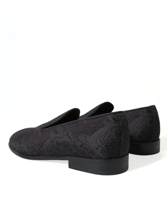 Pair of black velvet loafers with embroidered design on soles