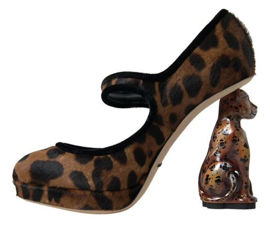 Leopard print high heel shoe with a small figurine of a dog on the heel
