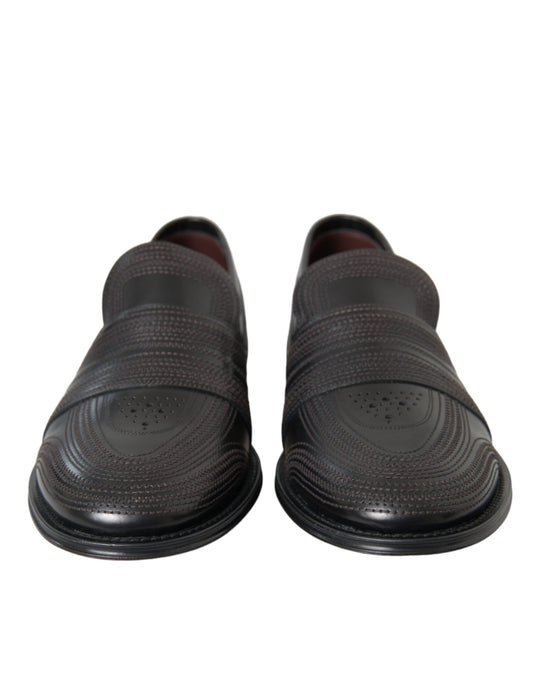 Pair of black shoes with a patterned design on top