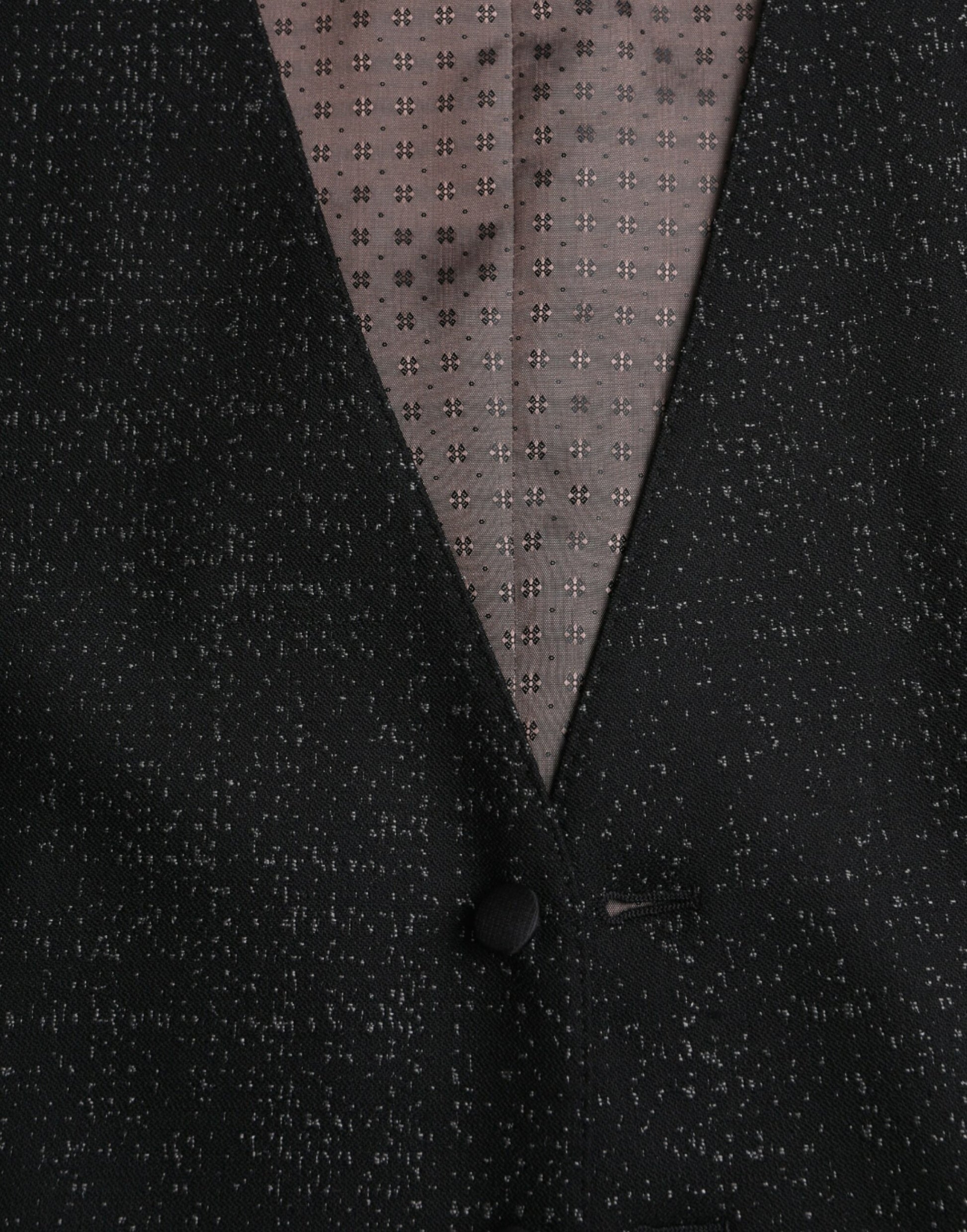 A black vest with brown and white patterned fabric on the front
