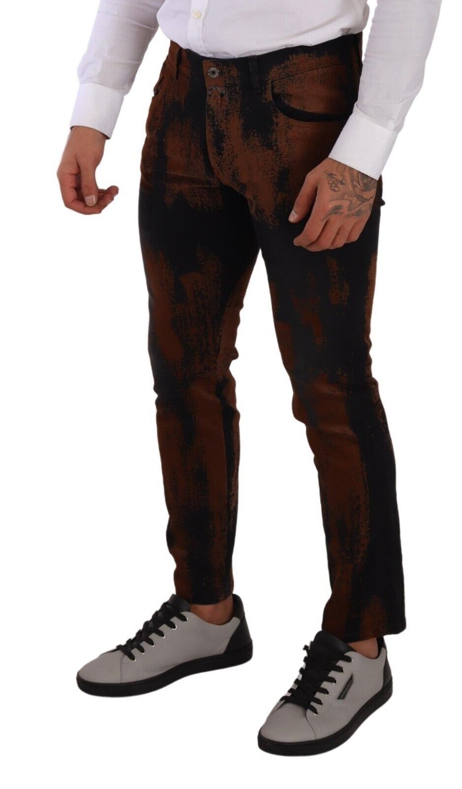 Man wearing brown pants, white shirt, and grey shoes