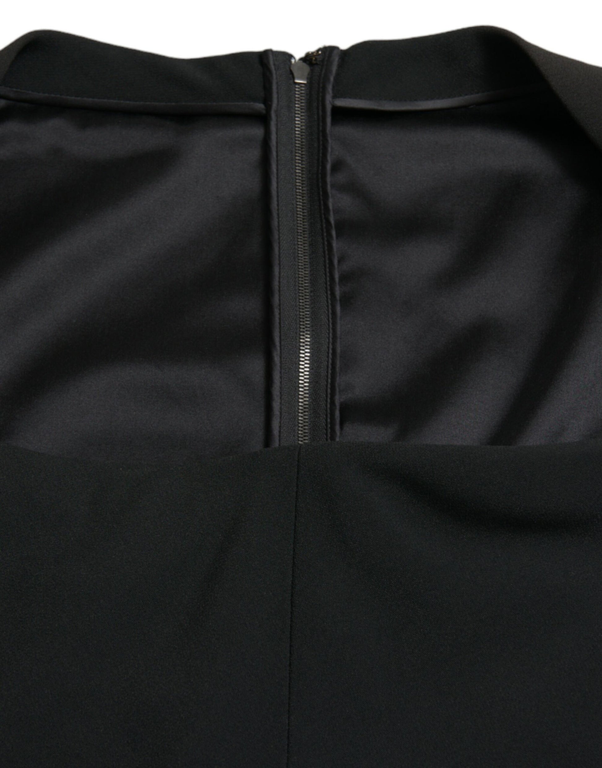 A black sleeveless dress with a zippered front and viscose material