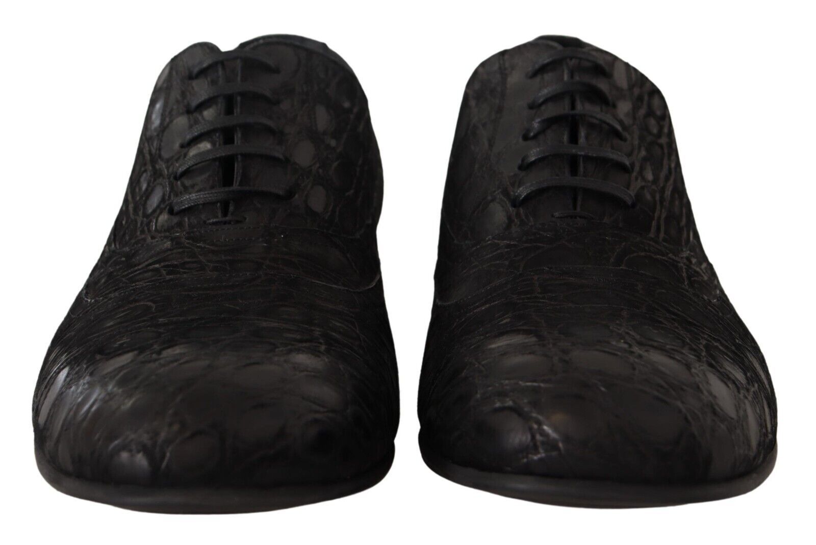 Pair of black patent leather dress shoes with laces and a bow tie design on top