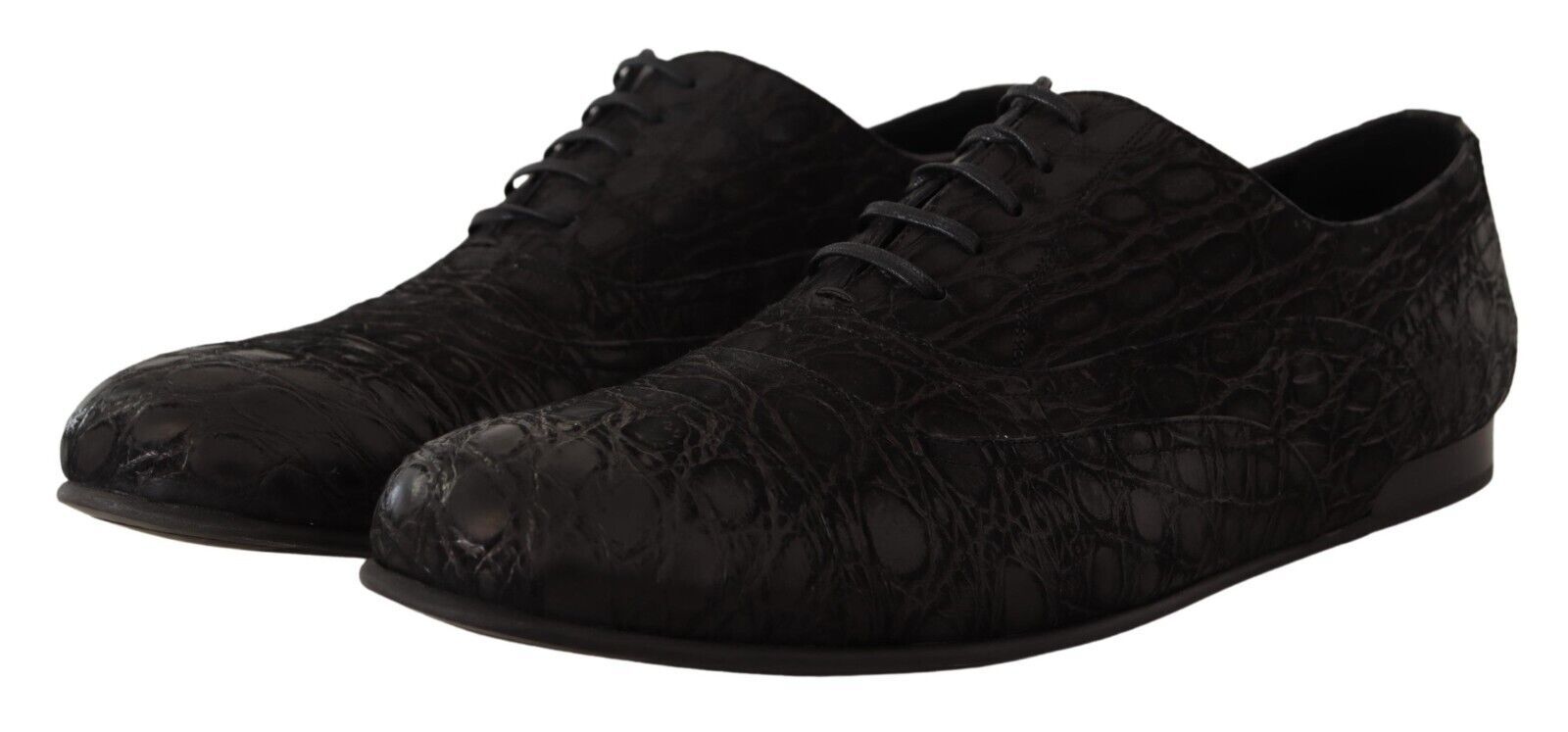 Pair of black dress shoes with laces and a patterned texture on the upper