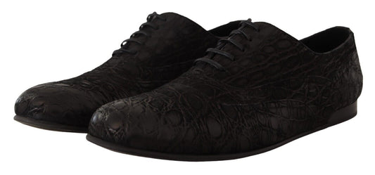 Pair of black dress shoes with laces and a patterned texture on the upper