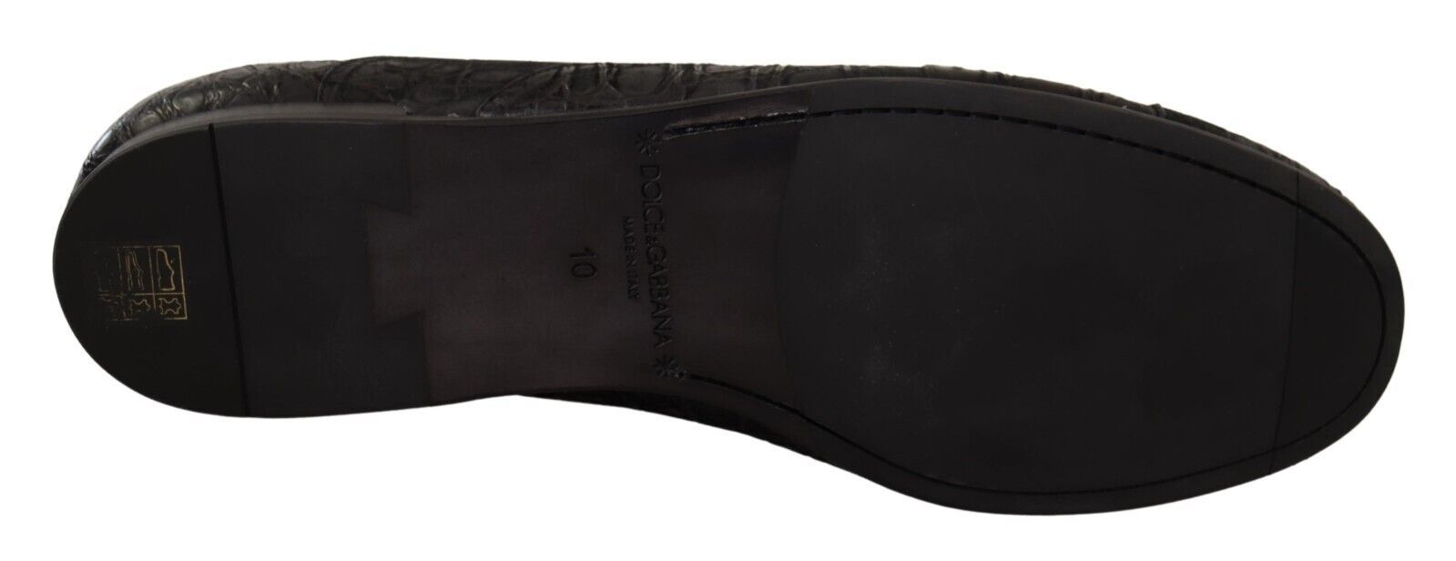 Black shoe with visible sole and laces