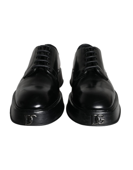 Pair of black leather dress shoes with laces and a small emblem on the side