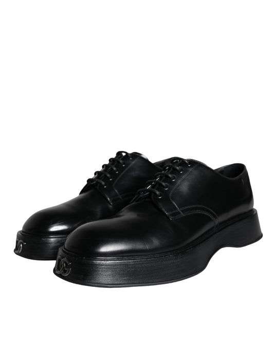 Pair of black leather dress shoes with laces and a small heel, featuring a shiny finish