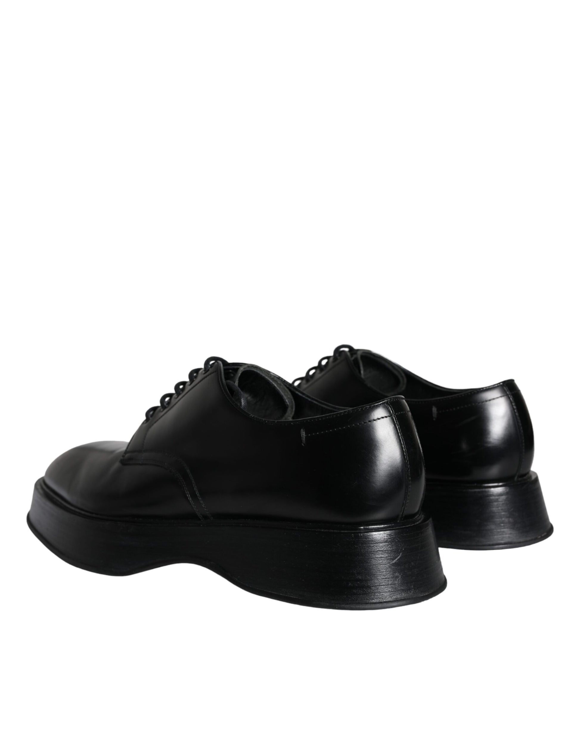 Pair of black leather dress shoes with laces and a low heel, featuring a polished finish