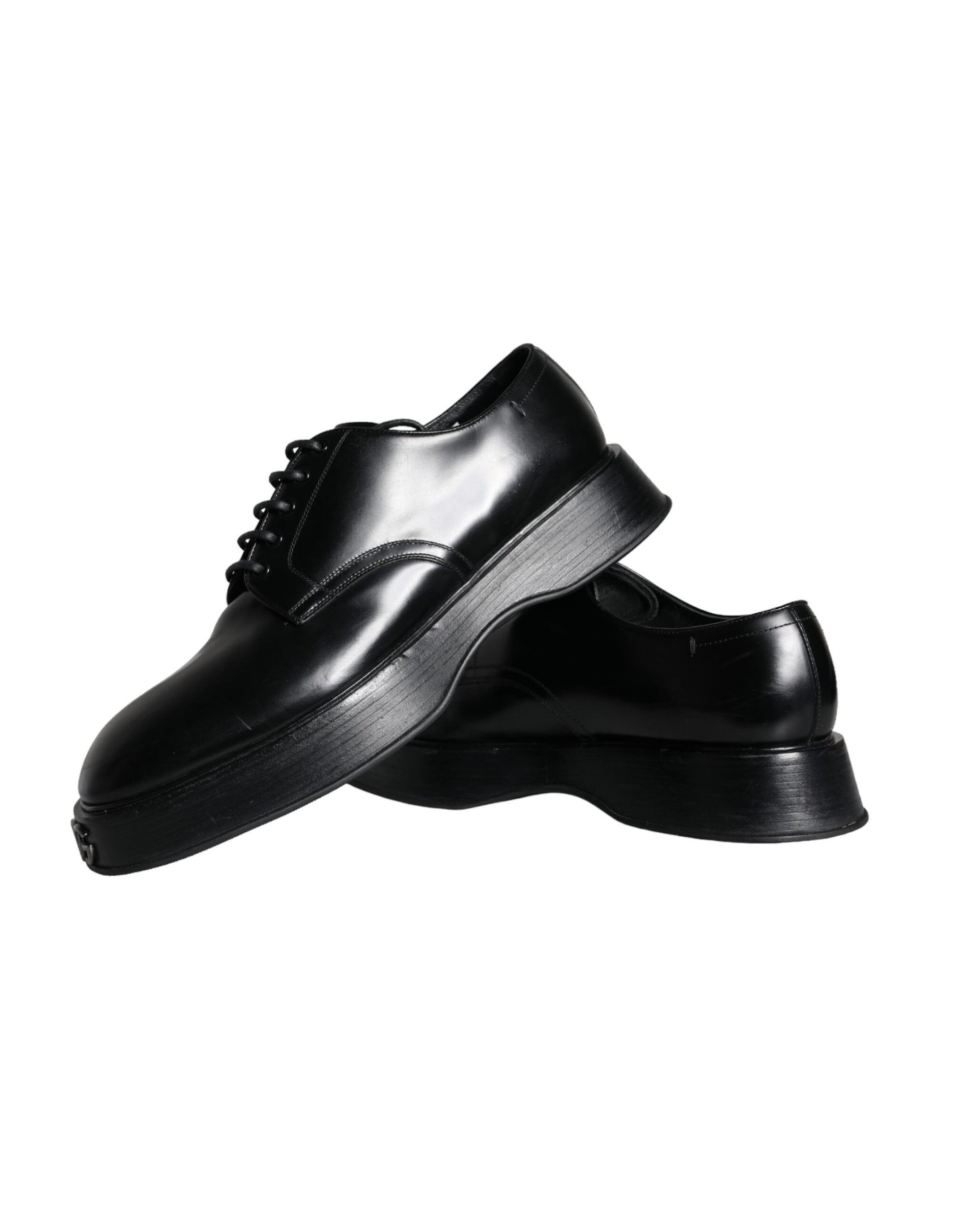 Pair of black leather dress shoes with laces, featuring a shiny finish and a low heel
