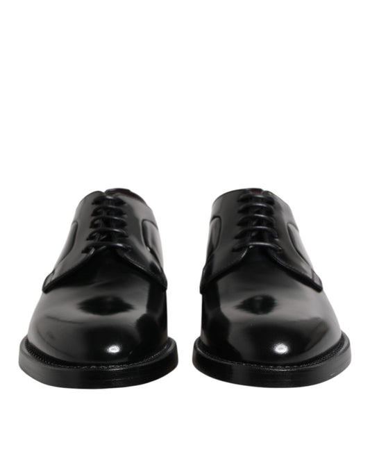 Pair of black leather dress shoes with laces, featuring a shiny finish and a classic design