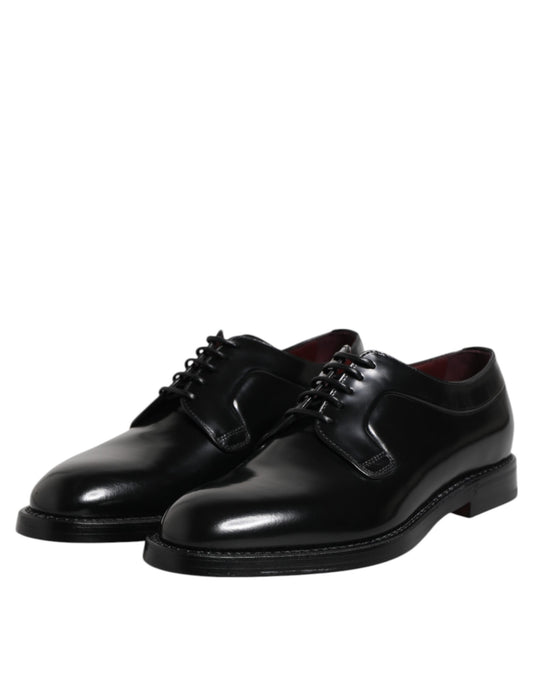 Pair of black leather lace-up dress shoes with a shiny finish