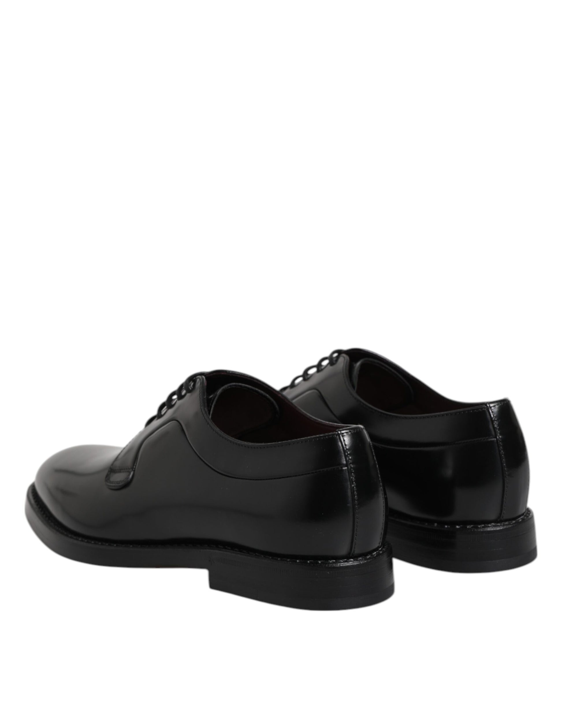 Pair of black lace-up dress shoes with a shiny finish, featuring a low heel and elastic panels for comfort