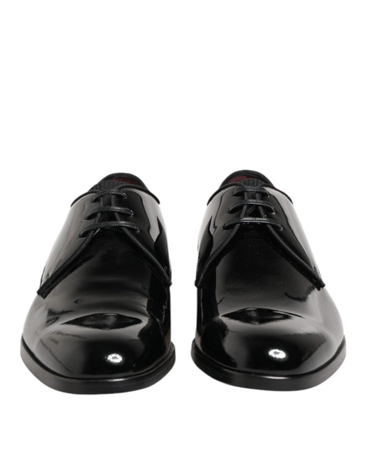 Pair of black leather dress shoes with laces and a shiny finish