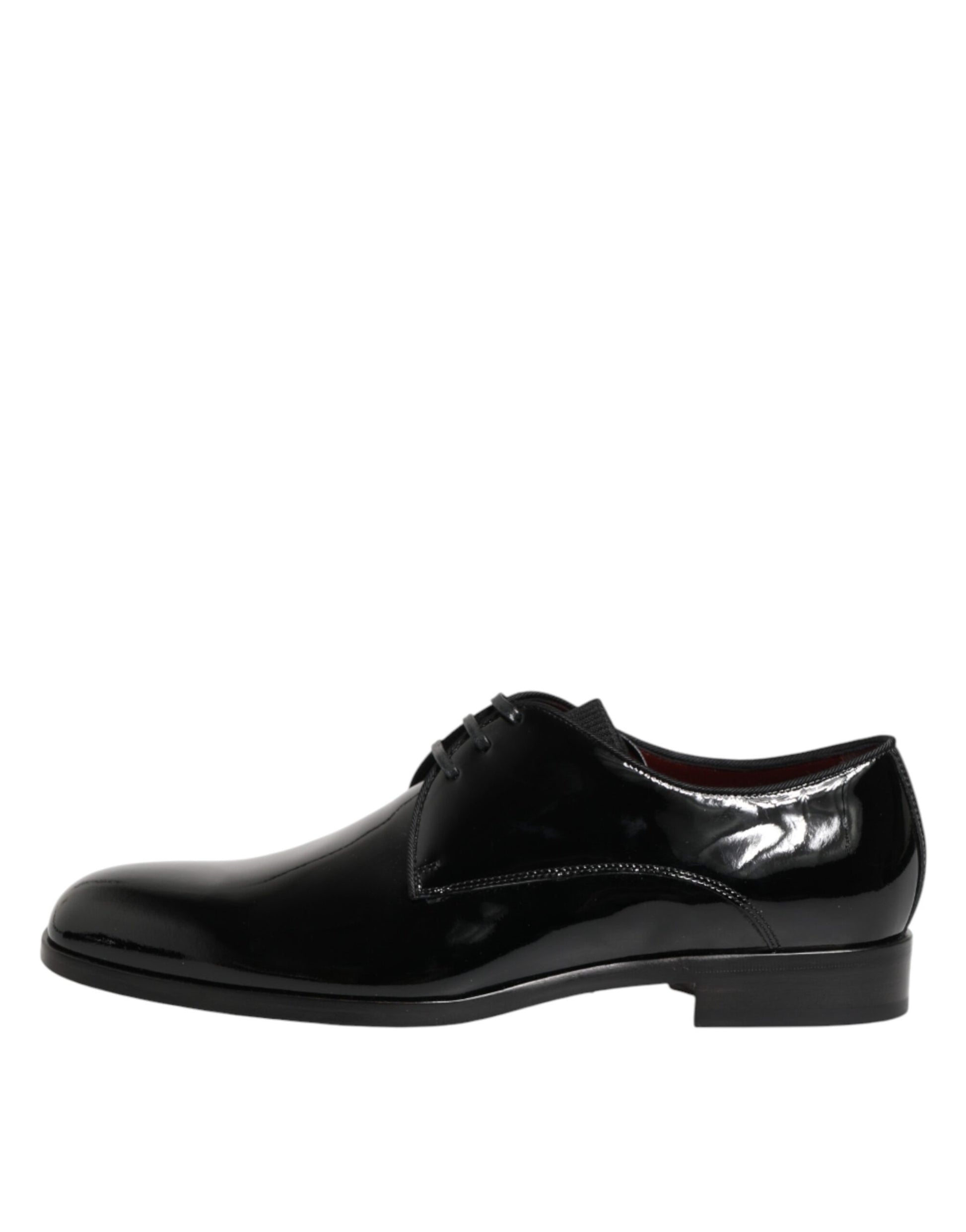 A pair of black leather dress shoes with laces and a strap across the top