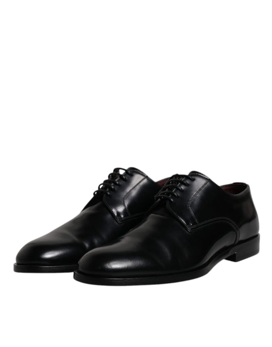 Pair of black leather lace-up dress shoes with a shiny finish