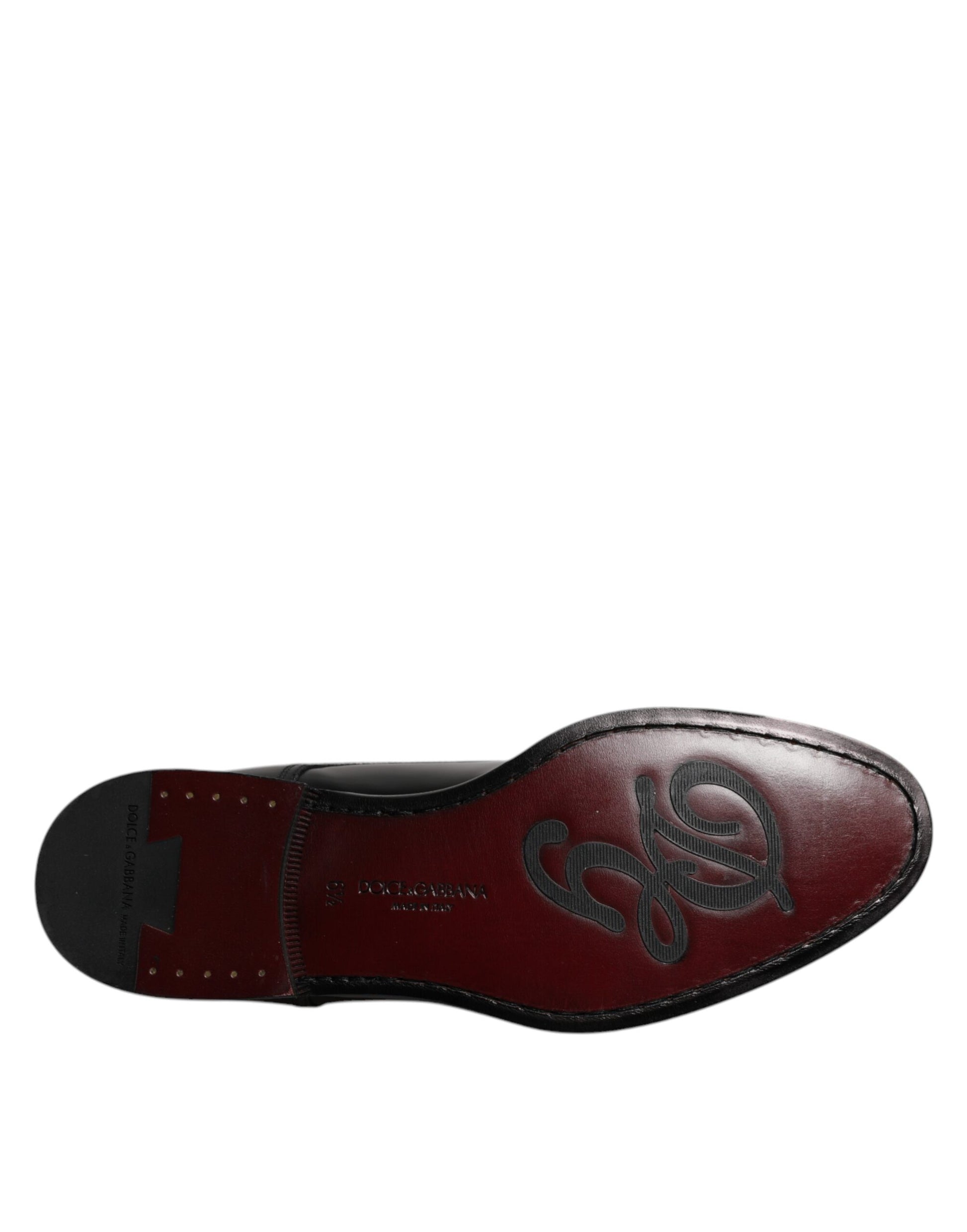 A pair of black leather lace-up shoes with a decorative emblem on the side