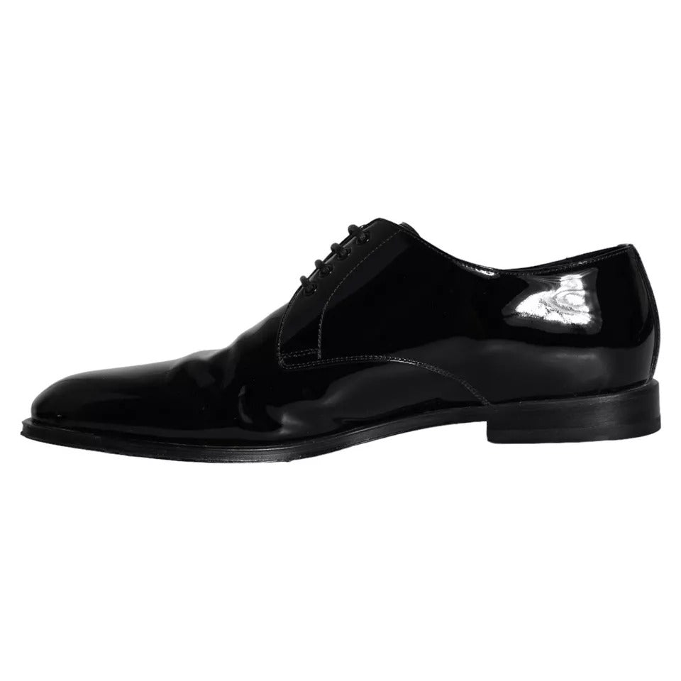 Pair of black leather dress shoes with laces and a shiny toe cap