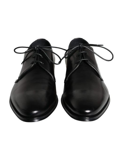 Pair of black leather dress shoes with laces and a shiny finish