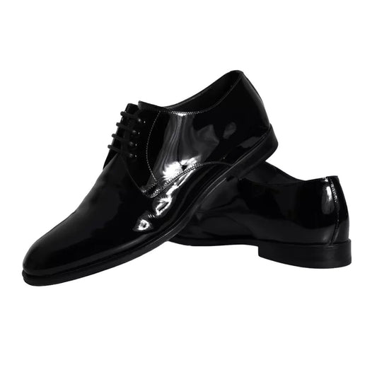 Pair of black leather dress shoes with laces and a bow tie design on the vamp