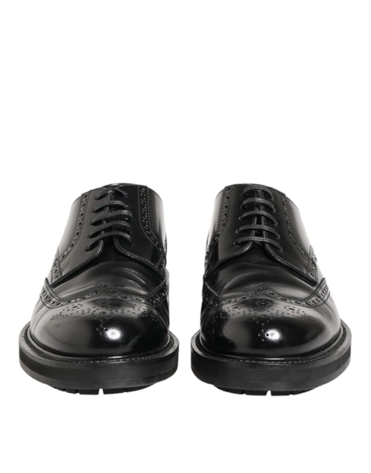 Pair of black leather dress shoes with laces and a shiny finish