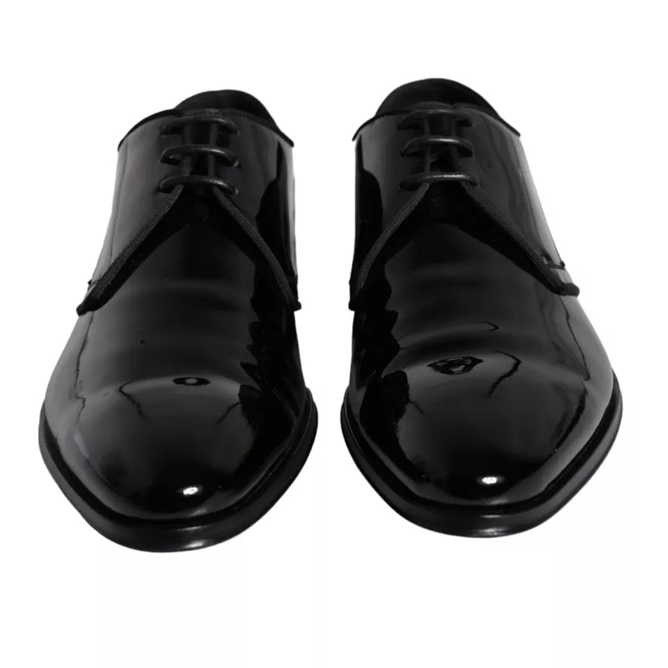Pair of black leather dress shoes with laces and a shiny finish