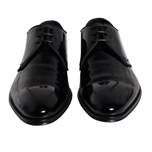 Pair of black leather dress shoes with laces and a shiny finish