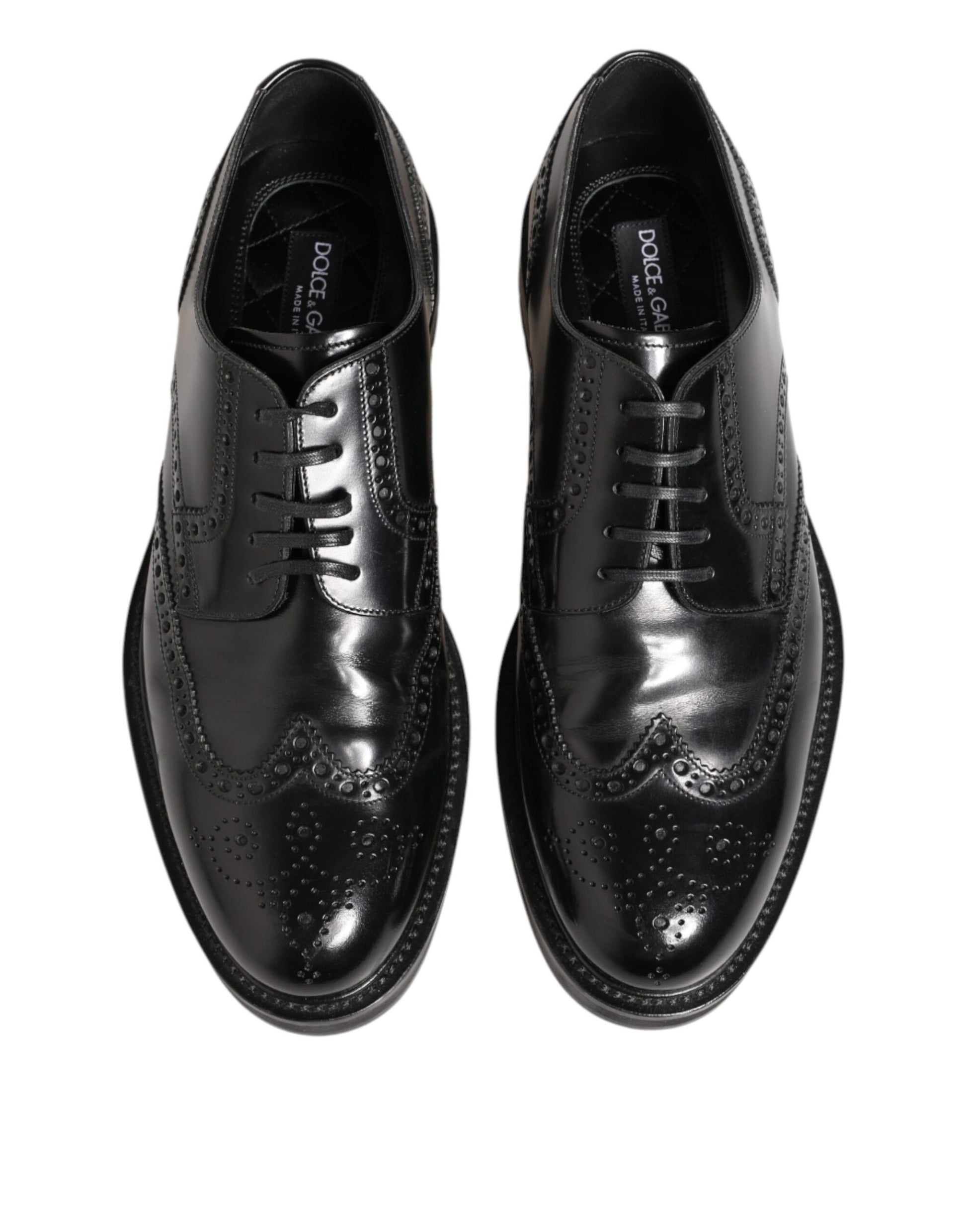 Pair of black leather dress shoes with laces and a small bow on the side