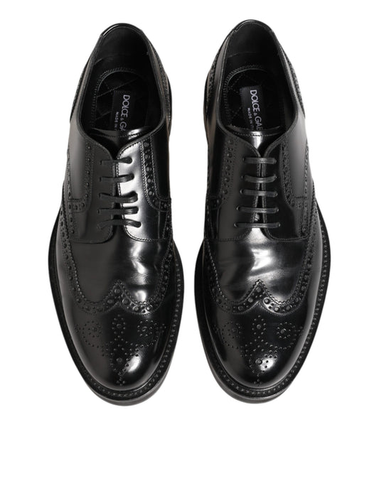 Pair of black leather dress shoes with laces and a small bow on the side
