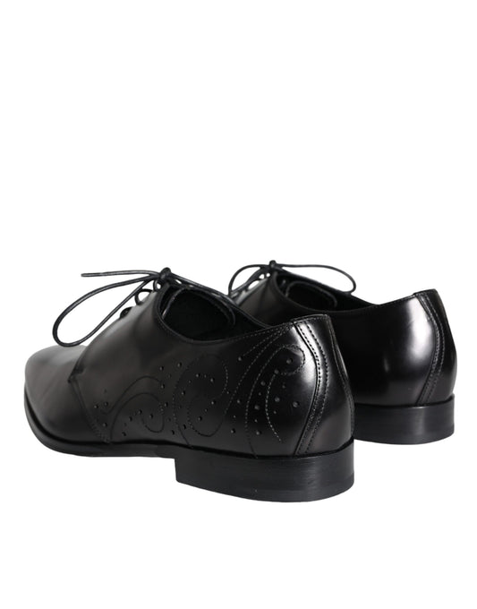 Pair of black leather dress shoes with laces and a small heel, featuring a textured design on the vamp