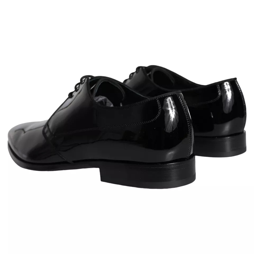 Pair of black leather dress shoes with laces, featuring a shiny finish and a low heel