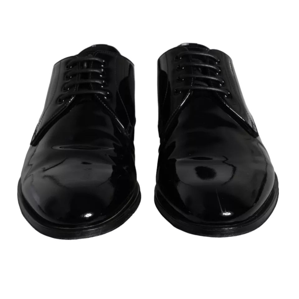 Pair of black leather dress shoes with laces and a shiny finish