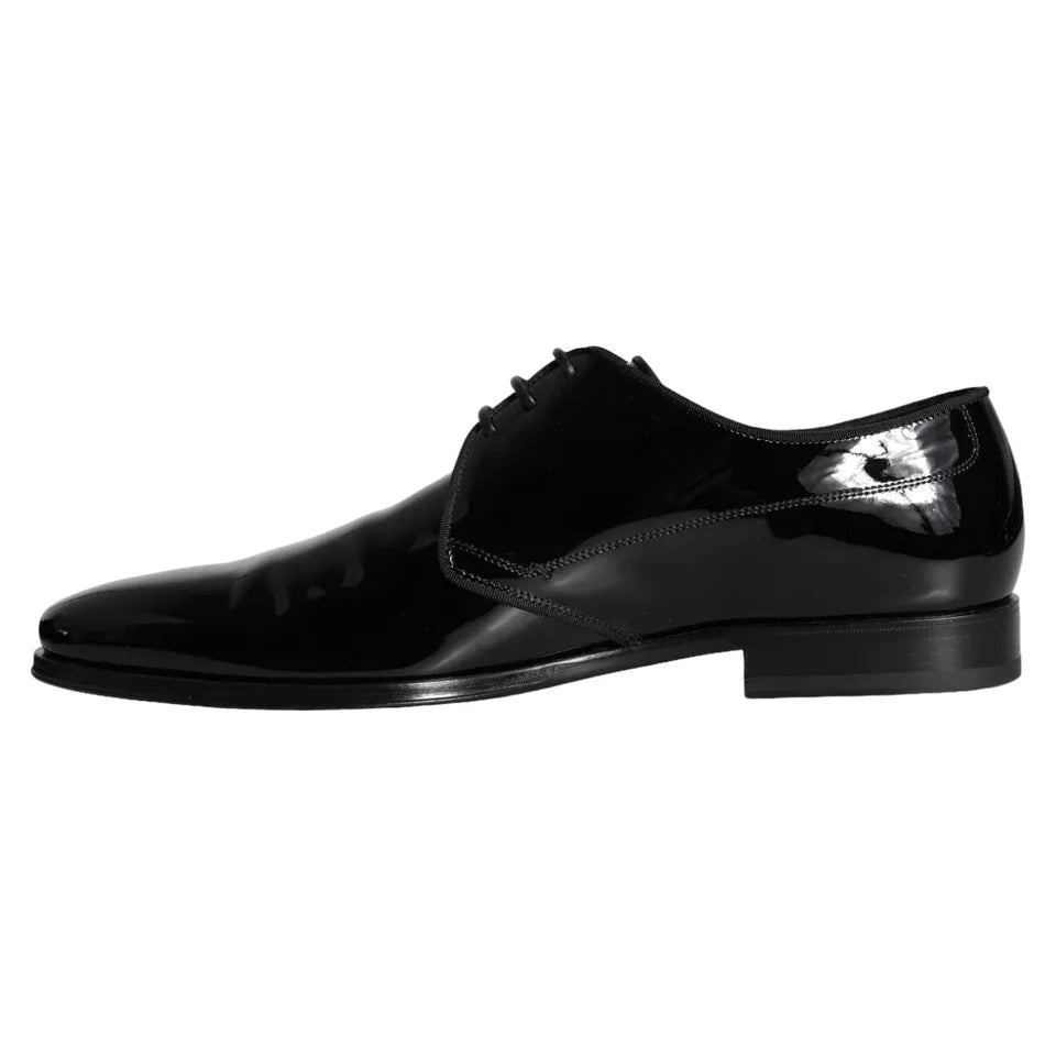 Pair of black leather dress shoes with laces and a small bow on the side