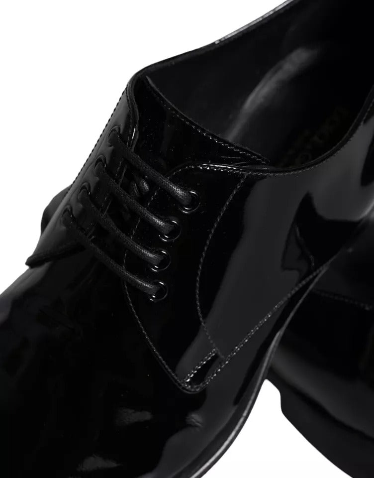 A pair of black leather dress shoes with laces and a shiny finish