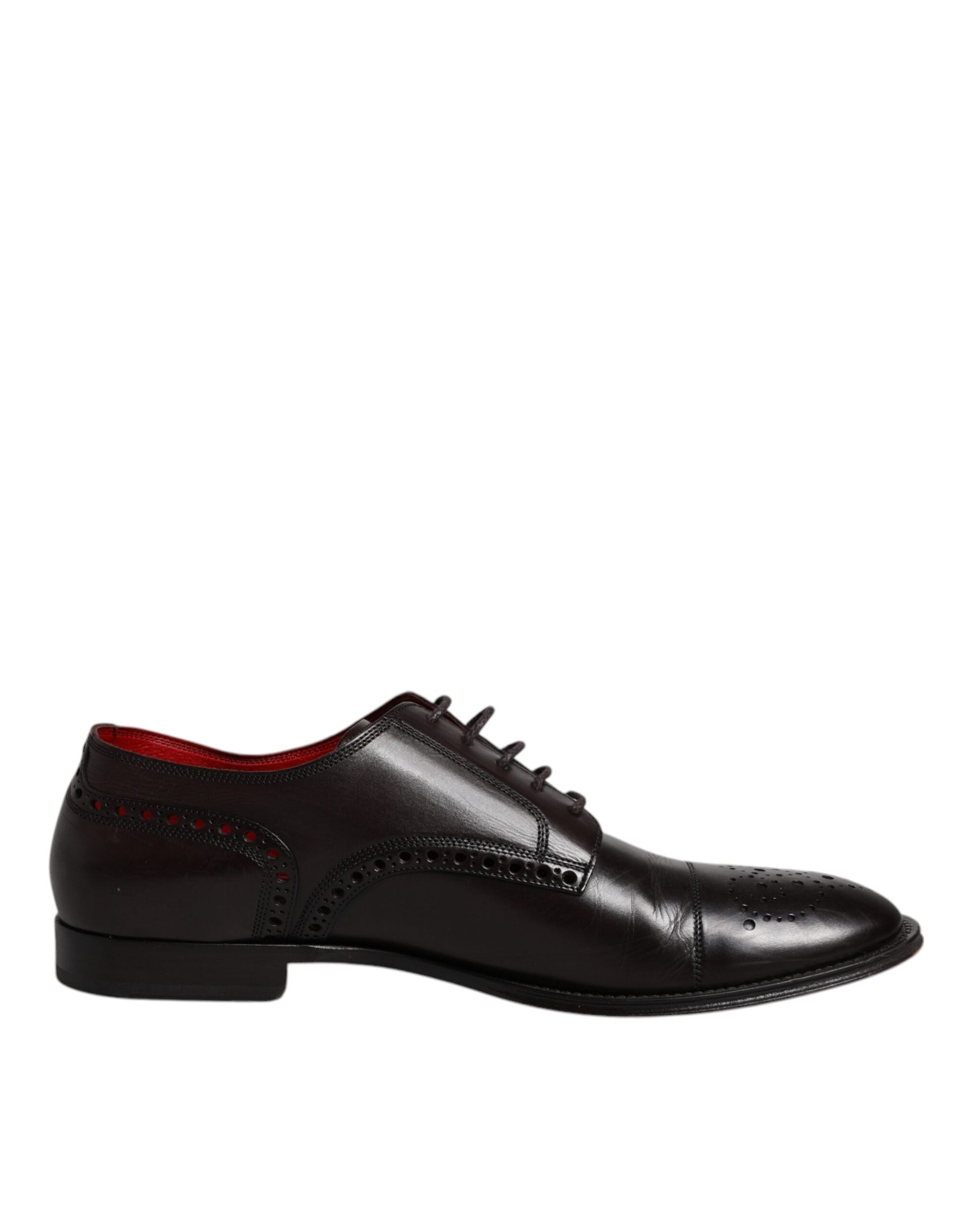 A pair of black leather dress shoes with red laces and a bow tie design