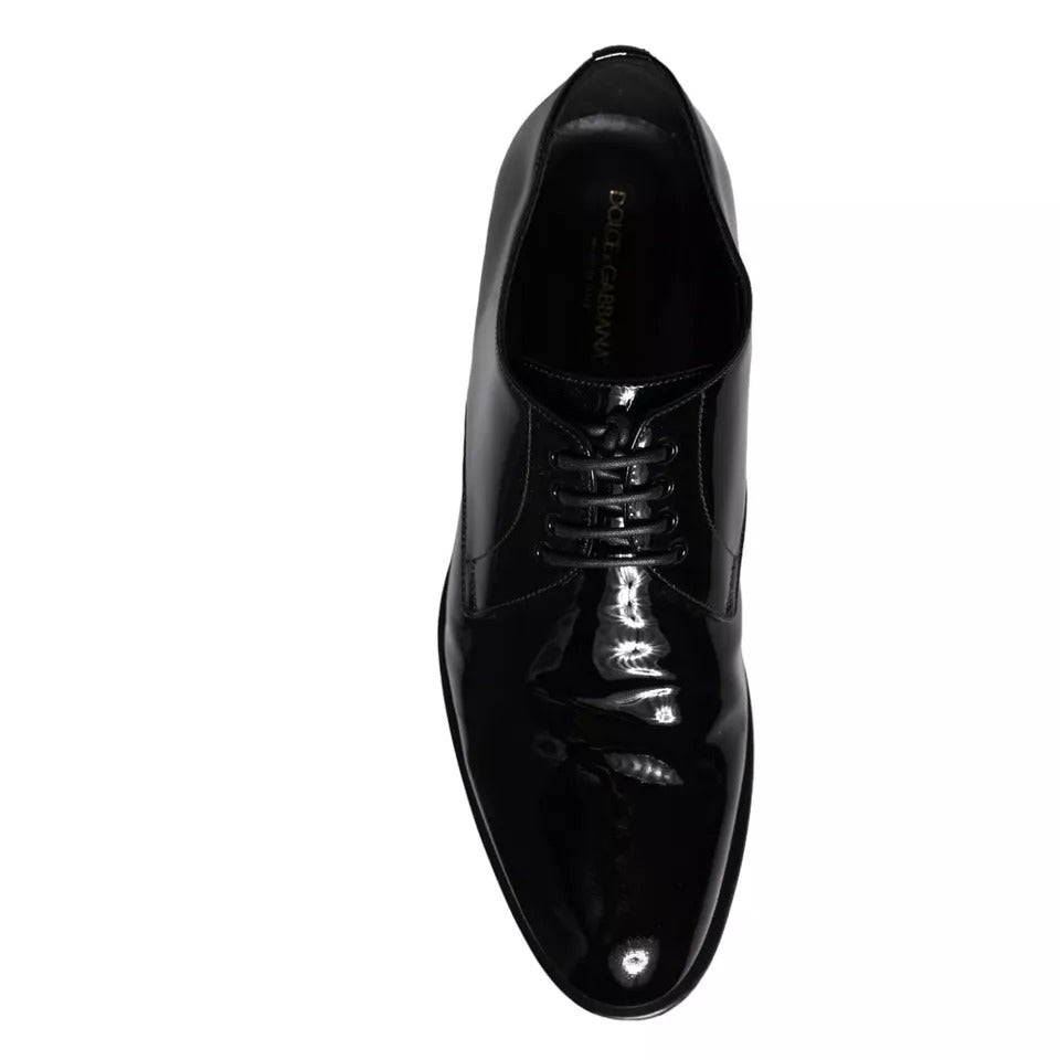A pair of black leather dress shoes with laces, featuring a shiny finish