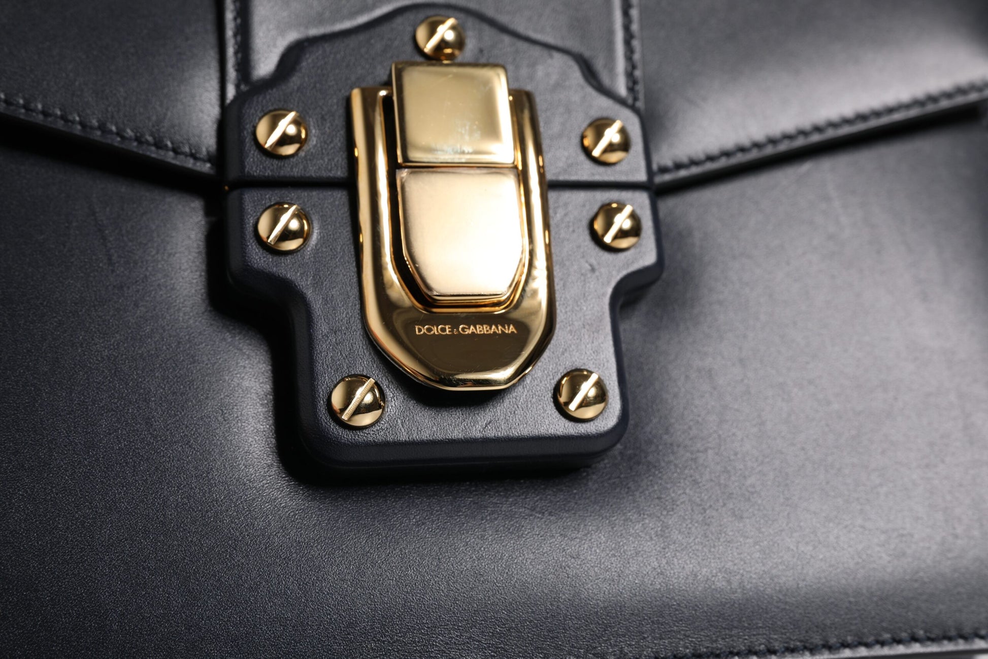 Gold hardware on black leather bag