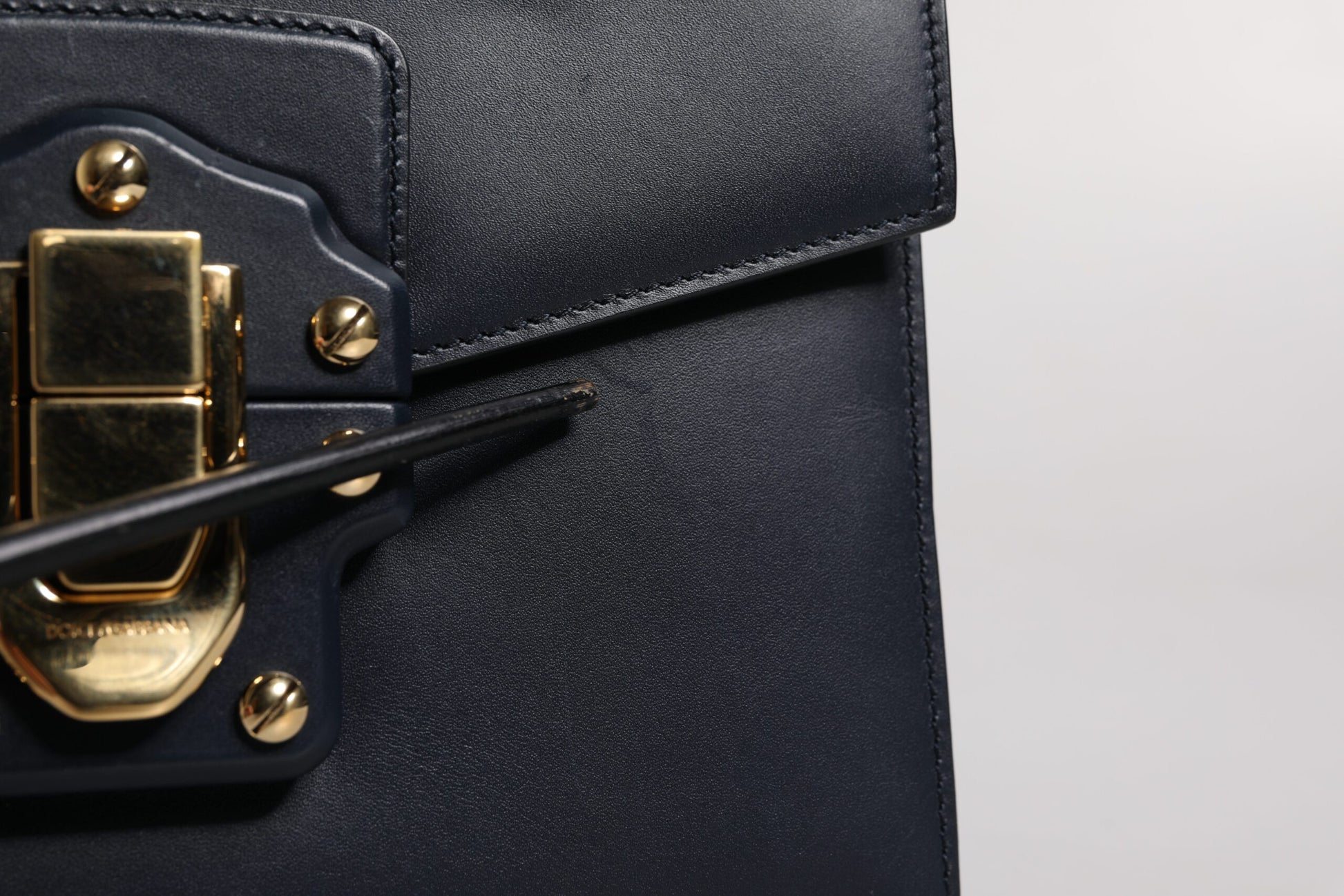 Black leather wallet with gold hardware