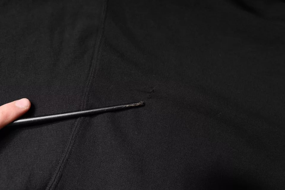 Black fabric with a small black object on top